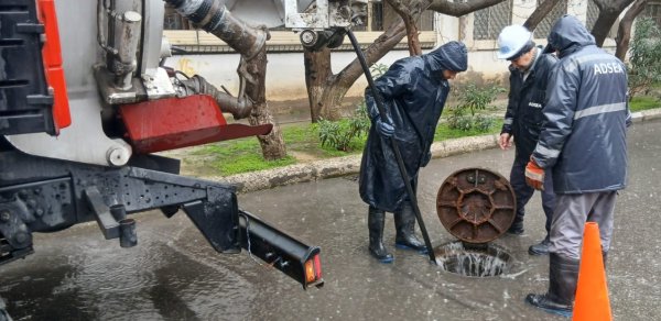 İki küçənin kəsişməsindəki ərazi yağış sularından təmizlənir